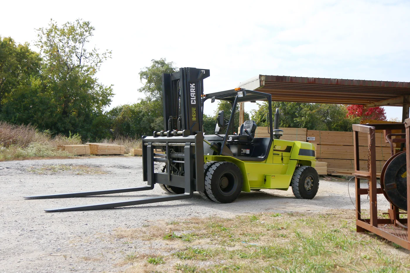 Pneumatic-tire forklift working an outdoor yard
